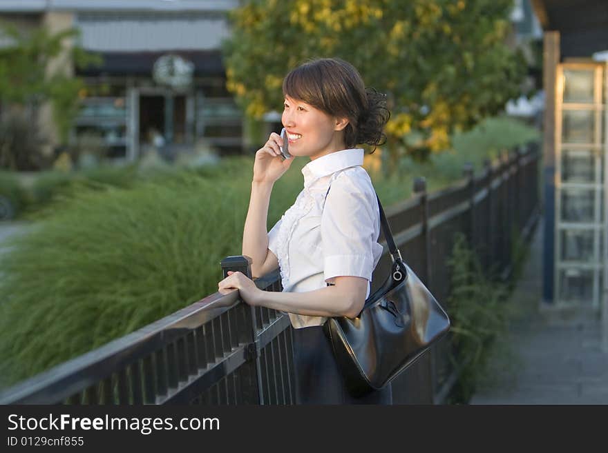 Smiling Woman Talking On Cellphone - Horizontal