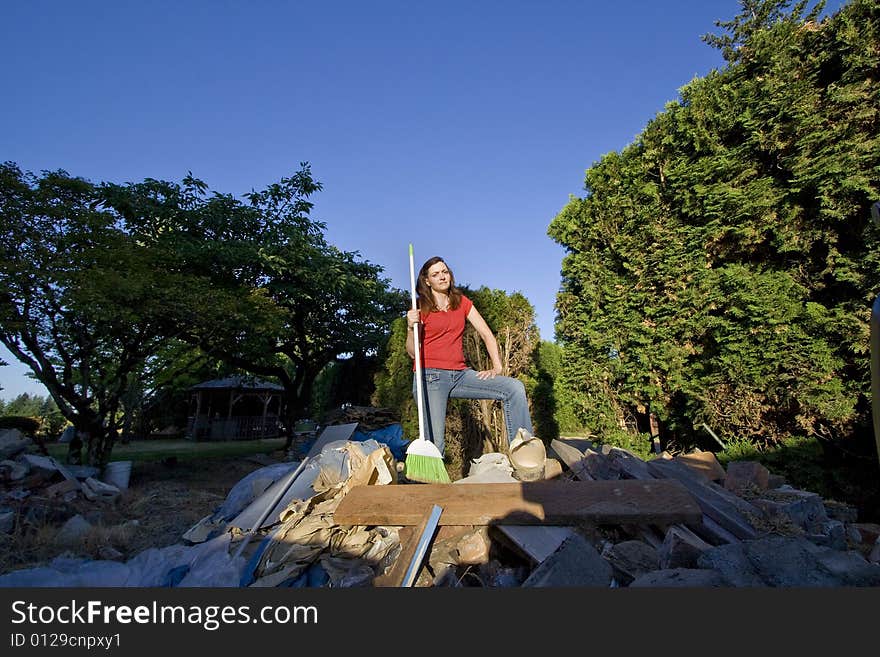 Woman Sweeping Through Garbage - Horizontal