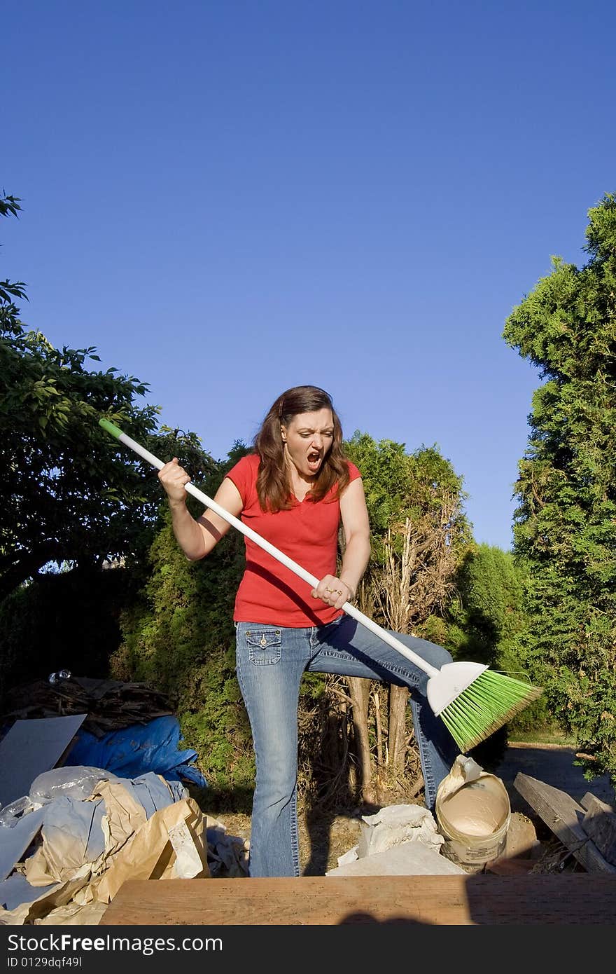 Woman Sweeping Through Garbage - Vertical