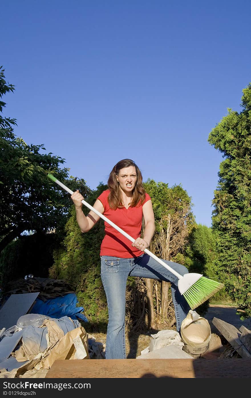 Woman Sweeping Through Garbage - Vertical