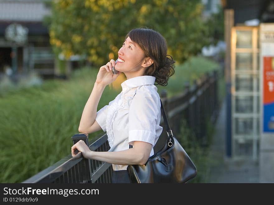 Smiling Woman Talking On Cellphone - Horizontal