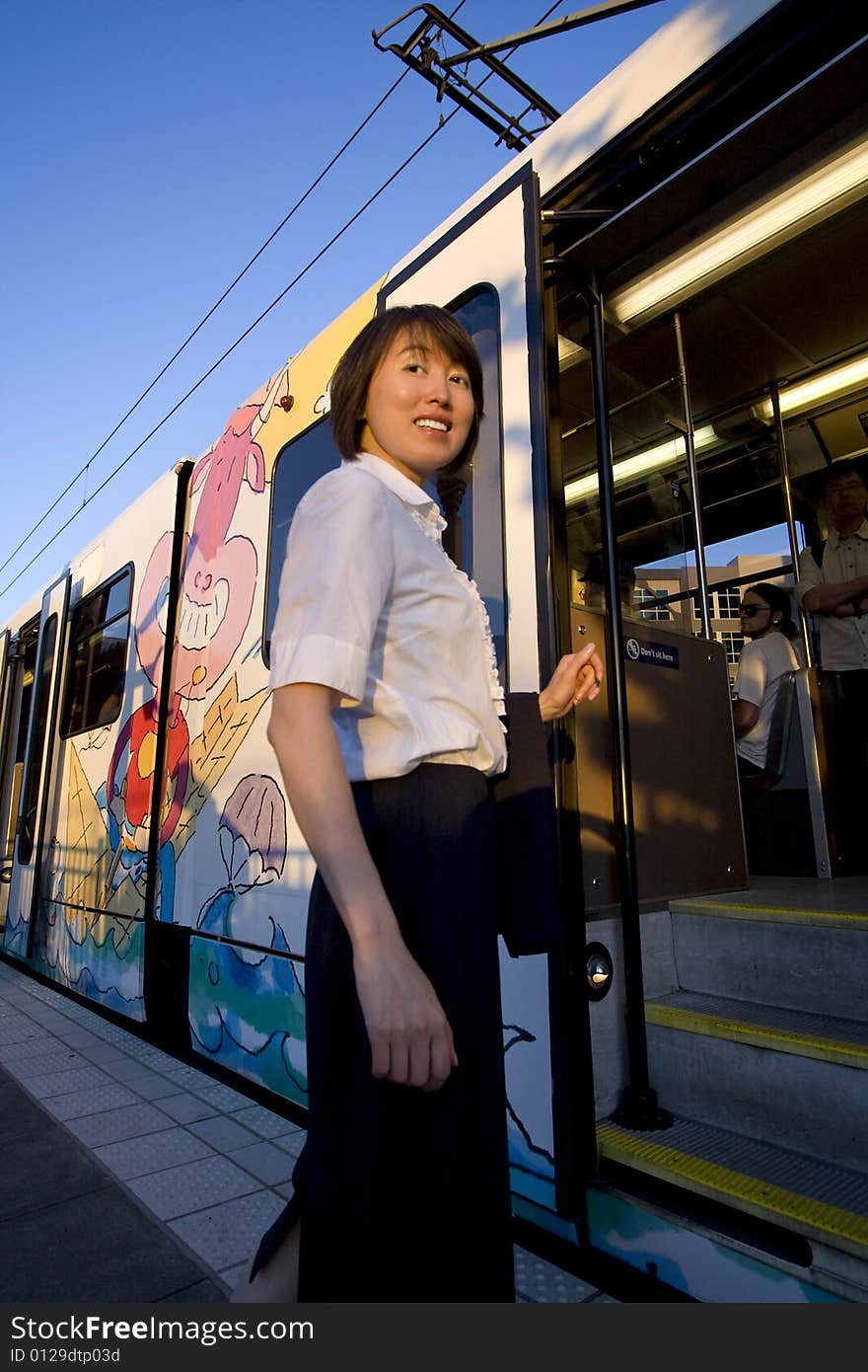 Smiling Woman Boards Train - Vertical