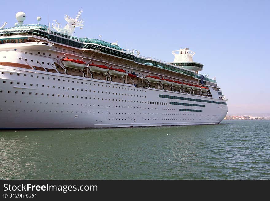 A big, older cruise ship is docked at the bay in San Diego, California.