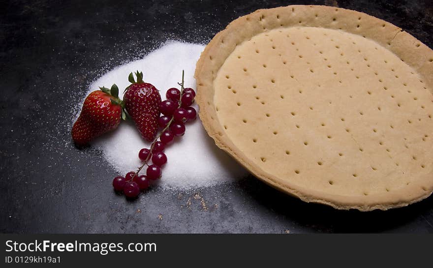 Tart shell with caster sugar strawberries and red currant. Tart shell with caster sugar strawberries and red currant