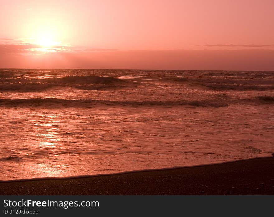 Pinkish sunset off the clouds and into the water. Pinkish sunset off the clouds and into the water