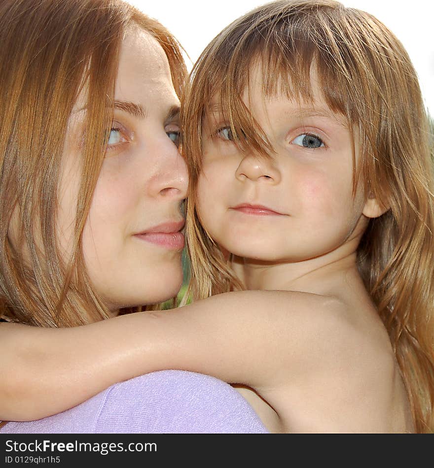 Young woman hugging a little girl. Young woman hugging a little girl