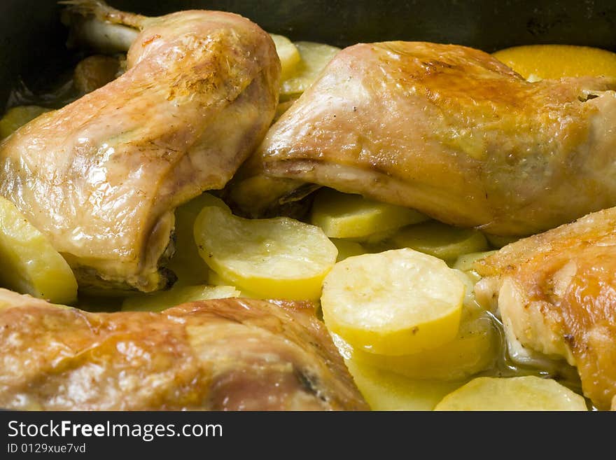 Chicken leg with roasted potato on olive oil