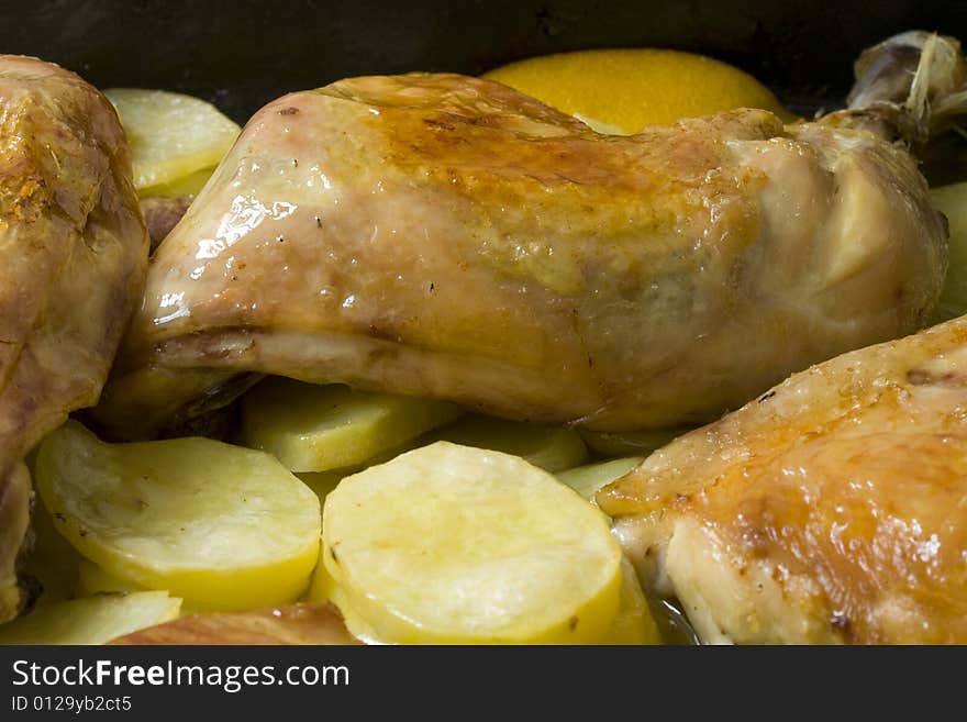 Chicken leg with roasted potato on olive oil