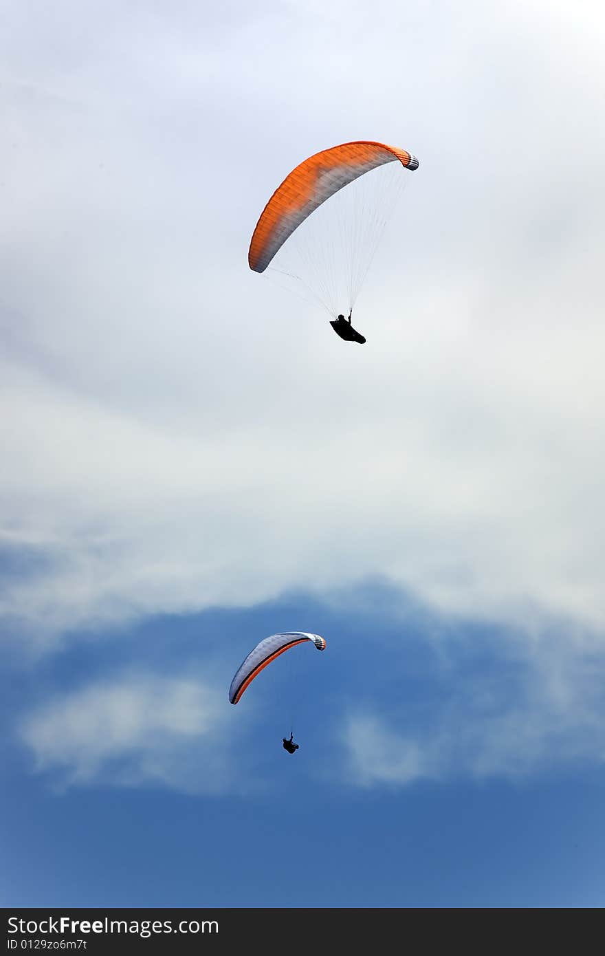 Two persons flying in blue sky. Two persons flying in blue sky