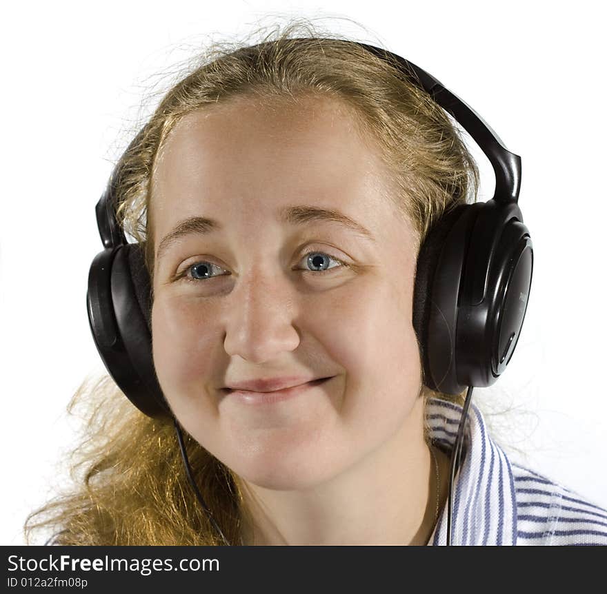 Young woman listening to music on headphones. Isolated on white. Young woman listening to music on headphones. Isolated on white