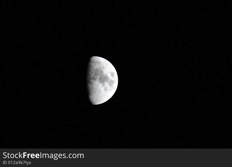 Moon close up on a dark black sky.