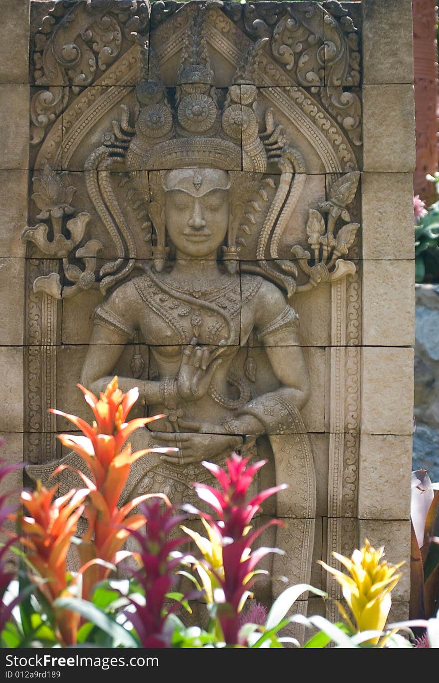 Emboss in Thai garden surrounded by flowers