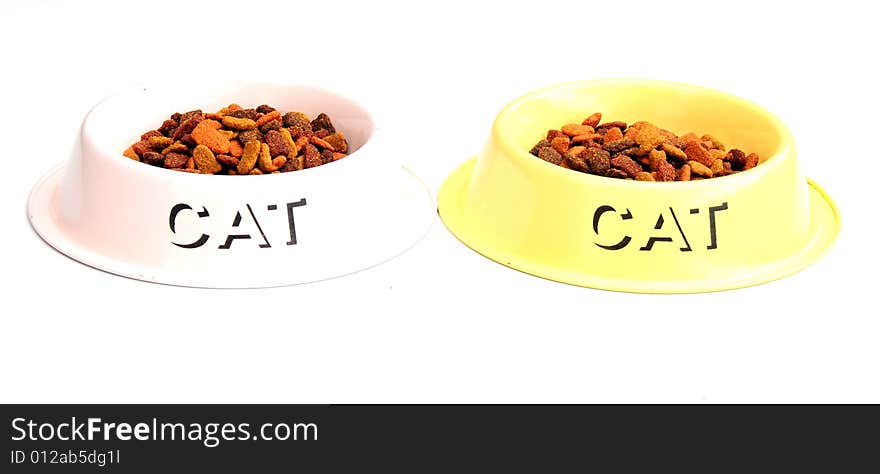 Shot of two cats feeding bowls with biscuits in. Shot of two cats feeding bowls with biscuits in