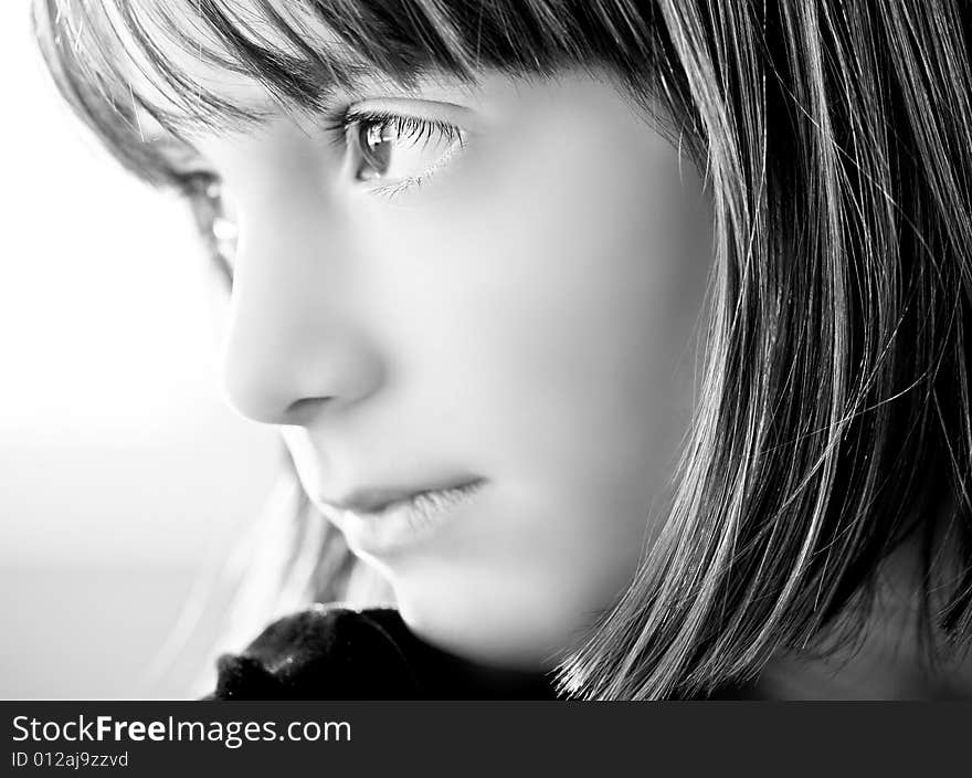 High fashion type black & white impact portrait of a young girl contemplating.