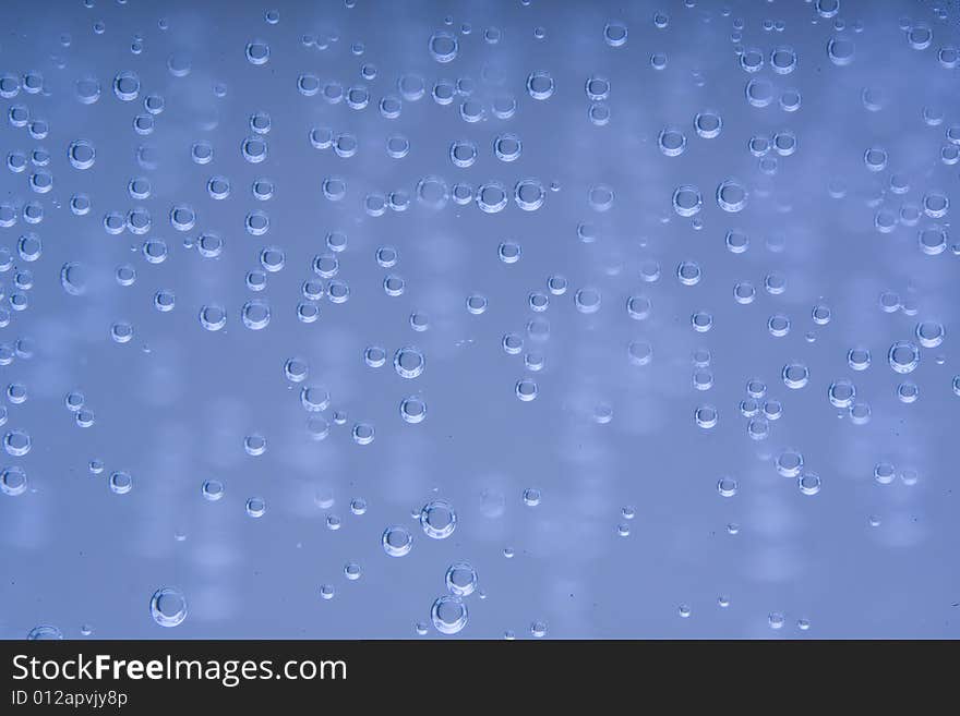 Drops of water on a blue background. Drops of water on a blue background