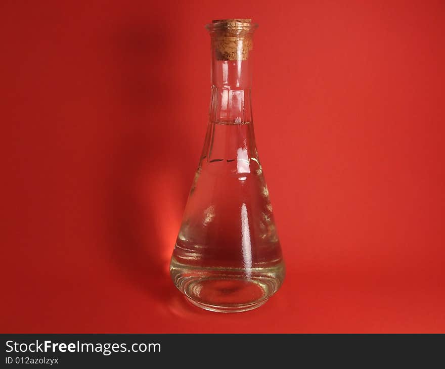 White wine bottle on red background