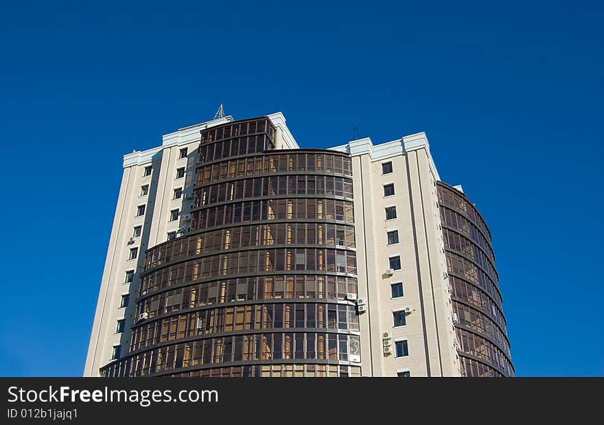 High modern office building with blue sky background