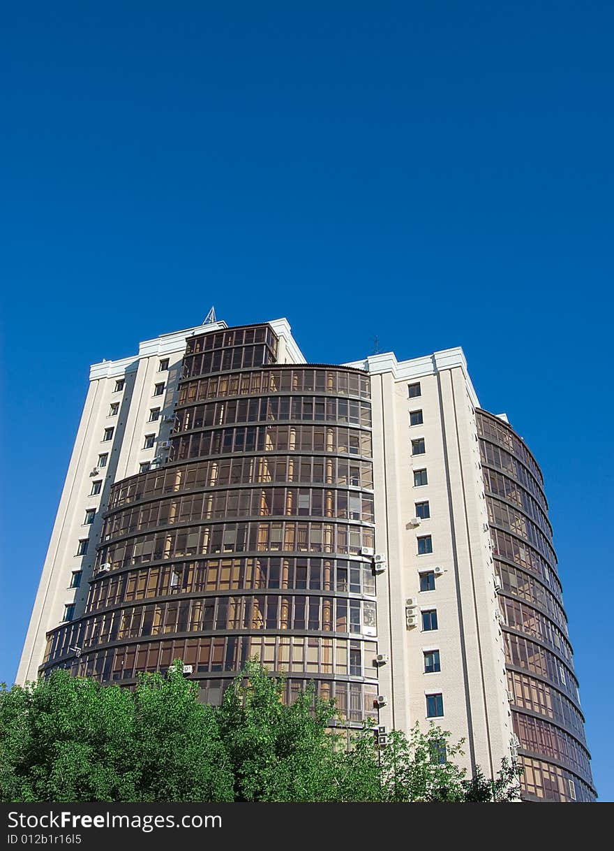 High modern office building with blue sky background