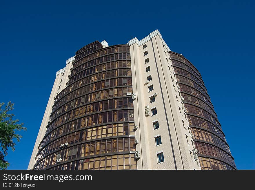 High modern office building with blue sky background