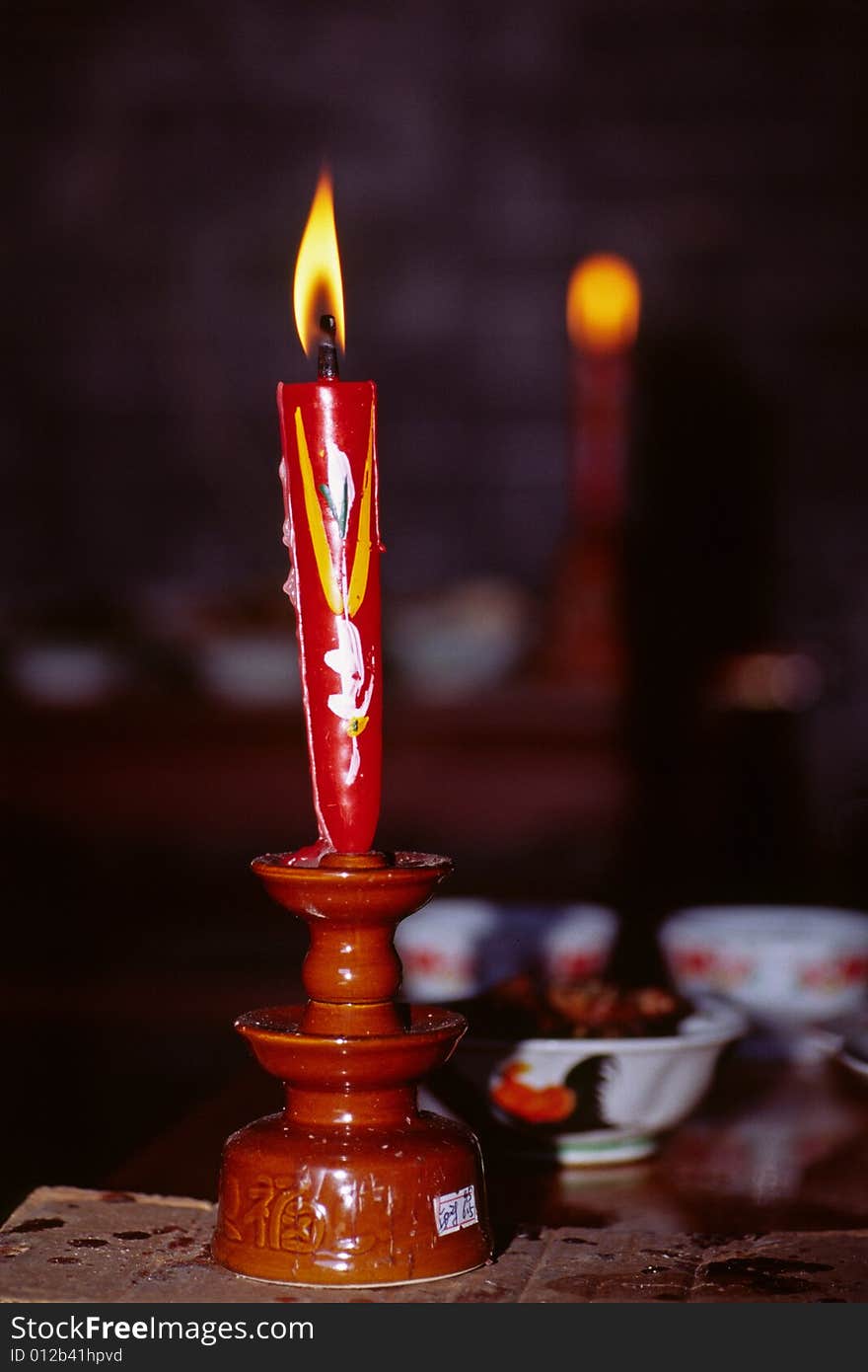 A red chinese candle burning at a sacrificing ceremony. A red chinese candle burning at a sacrificing ceremony