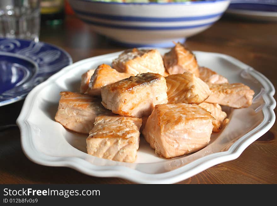 Salmon pieces on a white plate