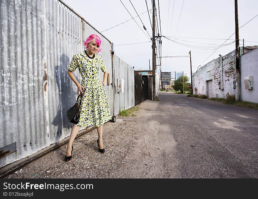 Woman with Pink Hair and a Purse in an Alley