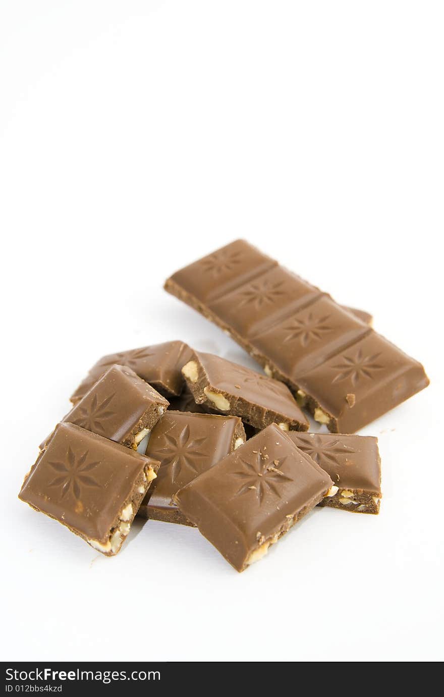 Milk chocolate with nuts on white background. Milk chocolate with nuts on white background