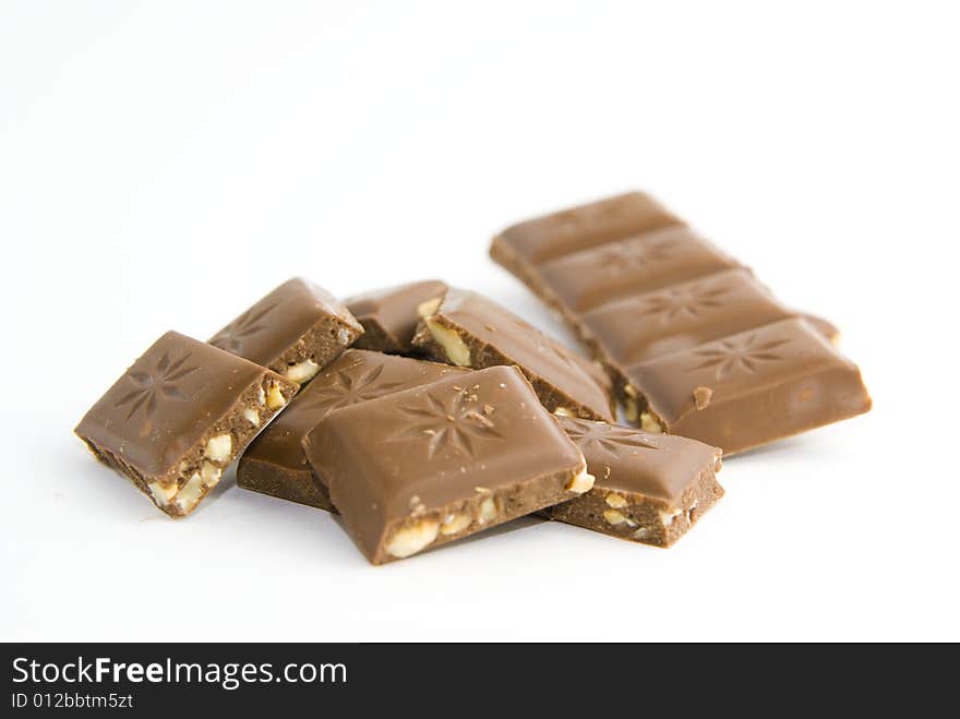 Milk chocolate with nuts on white background. Milk chocolate with nuts on white background