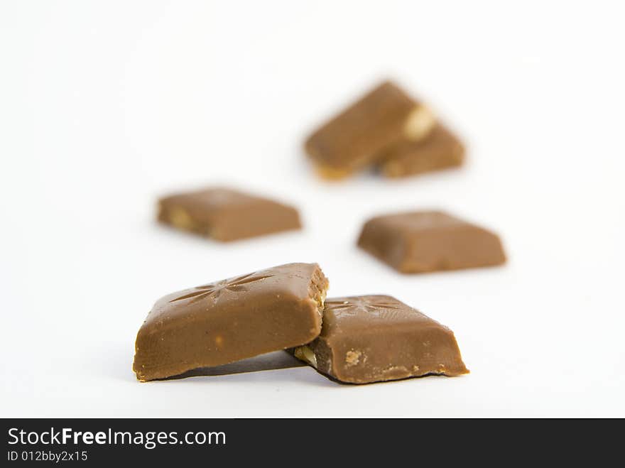 Milk chocolate with nuts on white background. Milk chocolate with nuts on white background