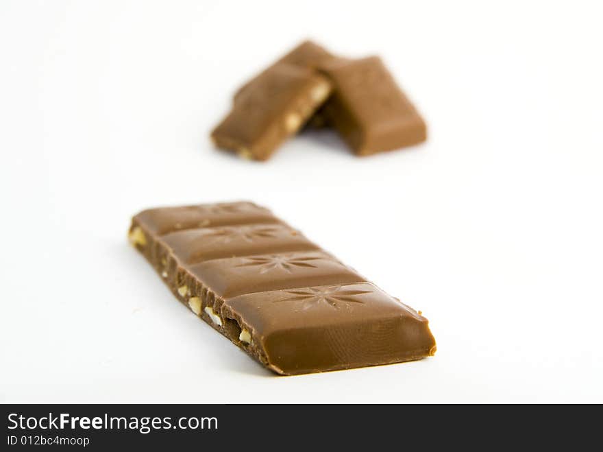 Milk chocolate with nuts on white background. Milk chocolate with nuts on white background