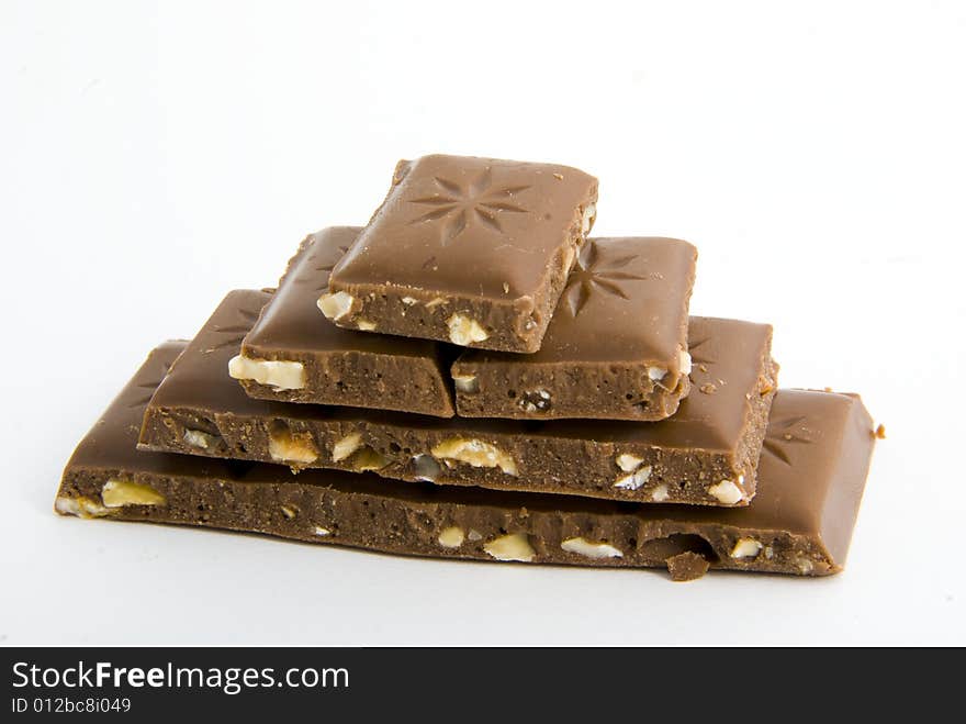 Milk chocolate with nuts on white background. Milk chocolate with nuts on white background