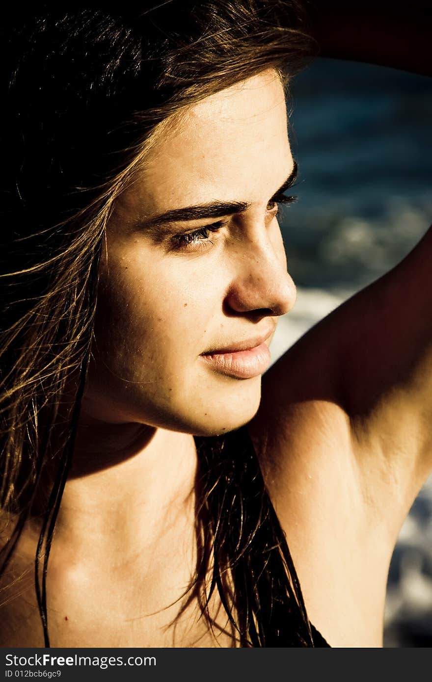 Beautiful green eyed woman portrait with the sea as background. Beautiful green eyed woman portrait with the sea as background.