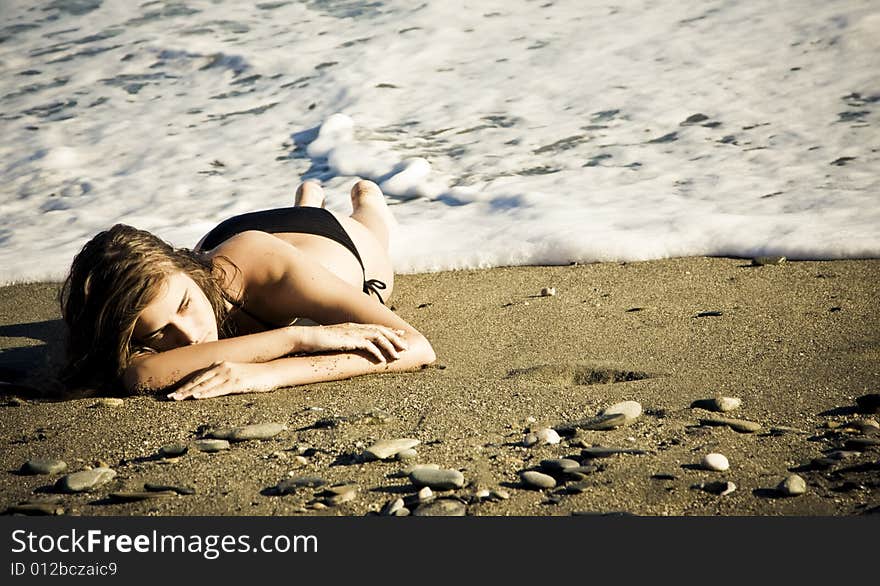 Green eyed beauty laying over the sand. Green eyed beauty laying over the sand