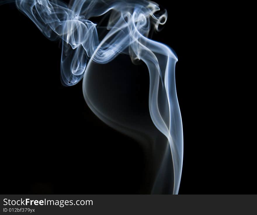 Colorful smoke curls isolated on black. Colorful smoke curls isolated on black