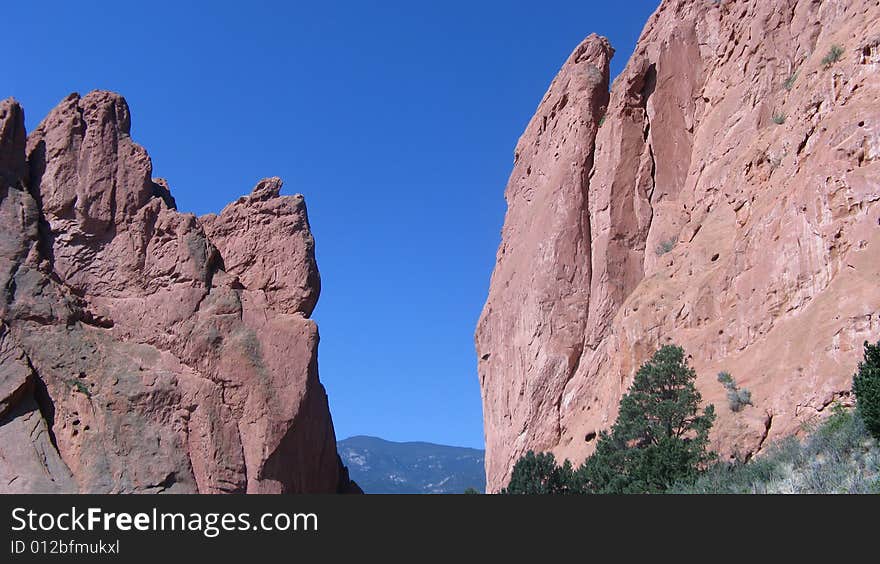 Looking thru a passage at the mountain range
with everything outlined against a deep blue sky. Looking thru a passage at the mountain range
with everything outlined against a deep blue sky.