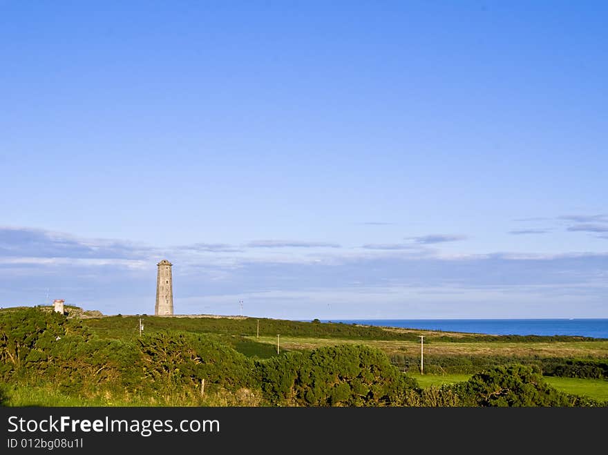 Old lighthouse in Wicklow, Ireland. A summer evening.