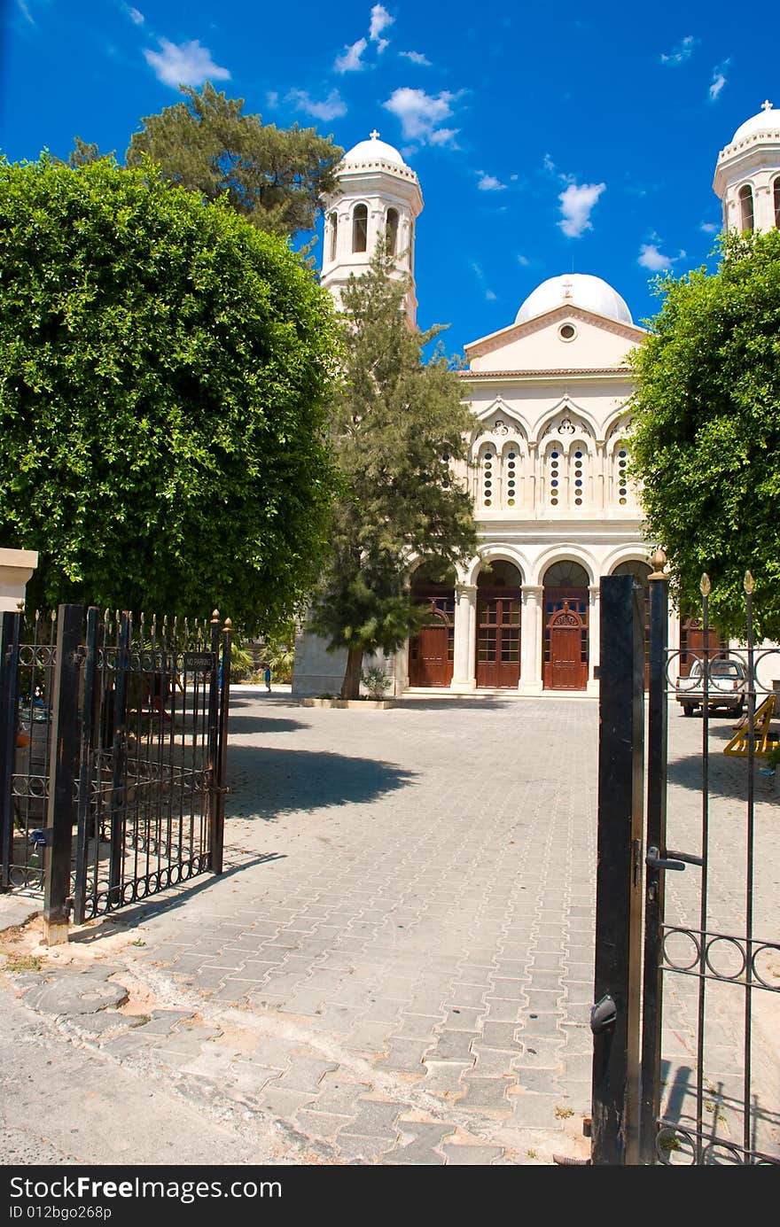 Path to church through steel gate with blue sky background. Path to church through steel gate with blue sky background