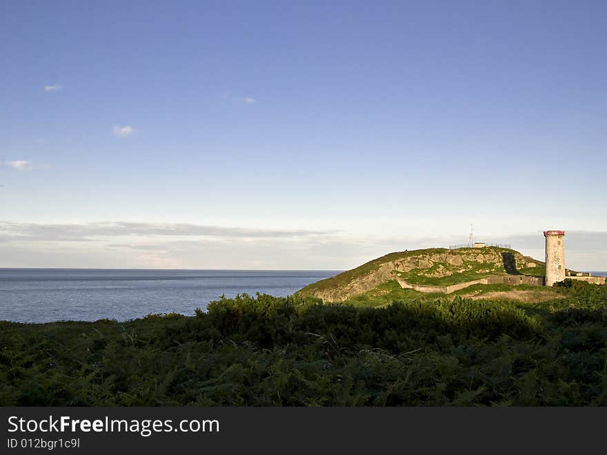 Old lighthouse in Wicklow, Ireland. A summer evening.