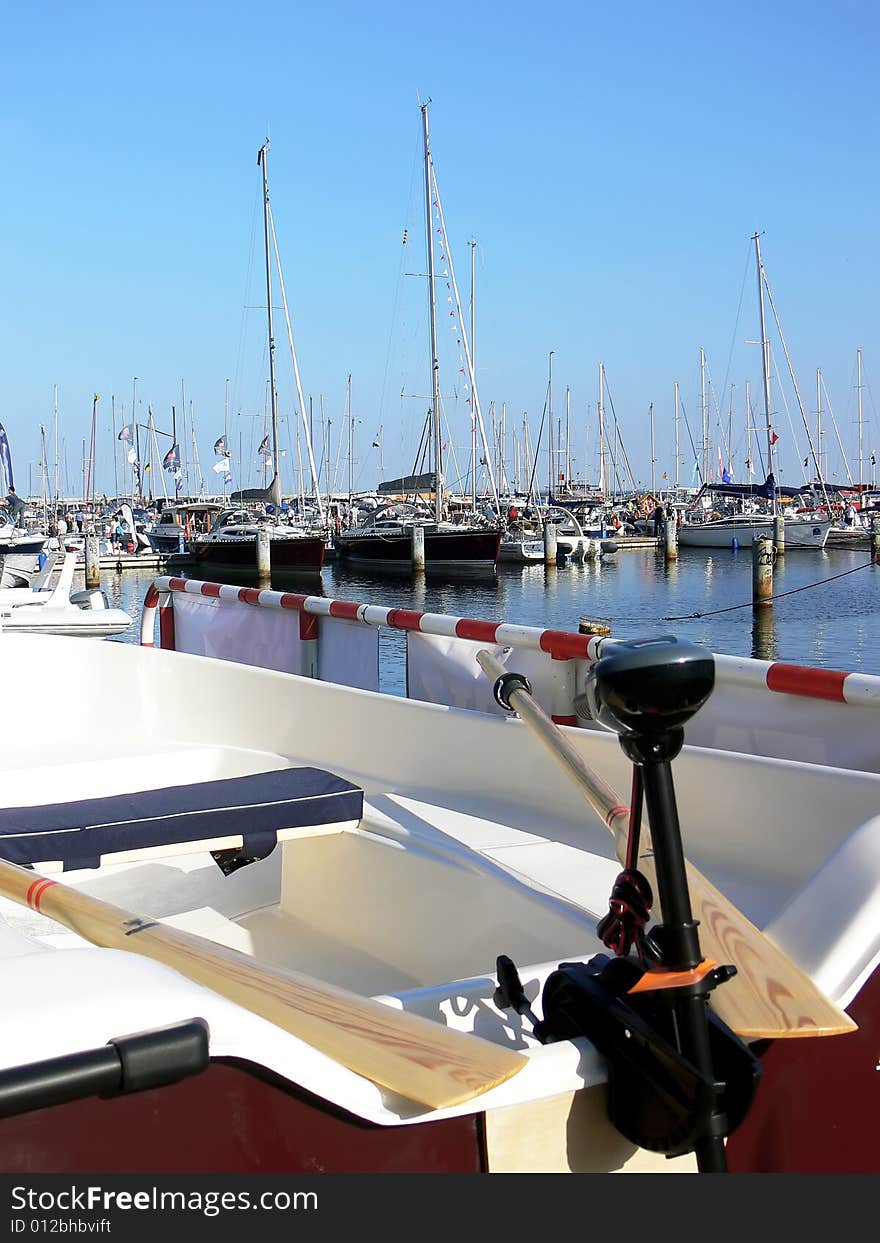 Small motor boat with wooden paddle in the harbour. Small motor boat with wooden paddle in the harbour.