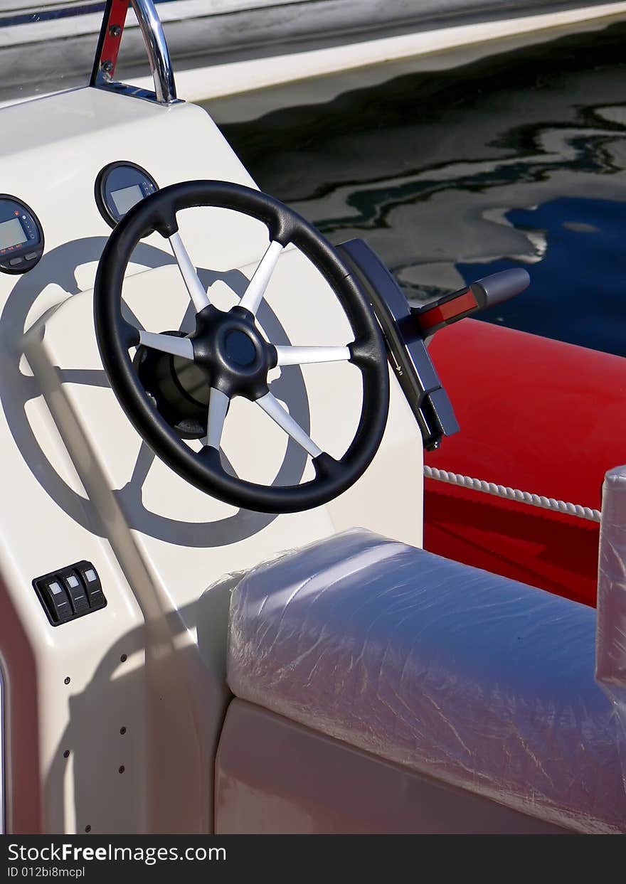 New motor boat wheel and control panel close up. New motor boat wheel and control panel close up.