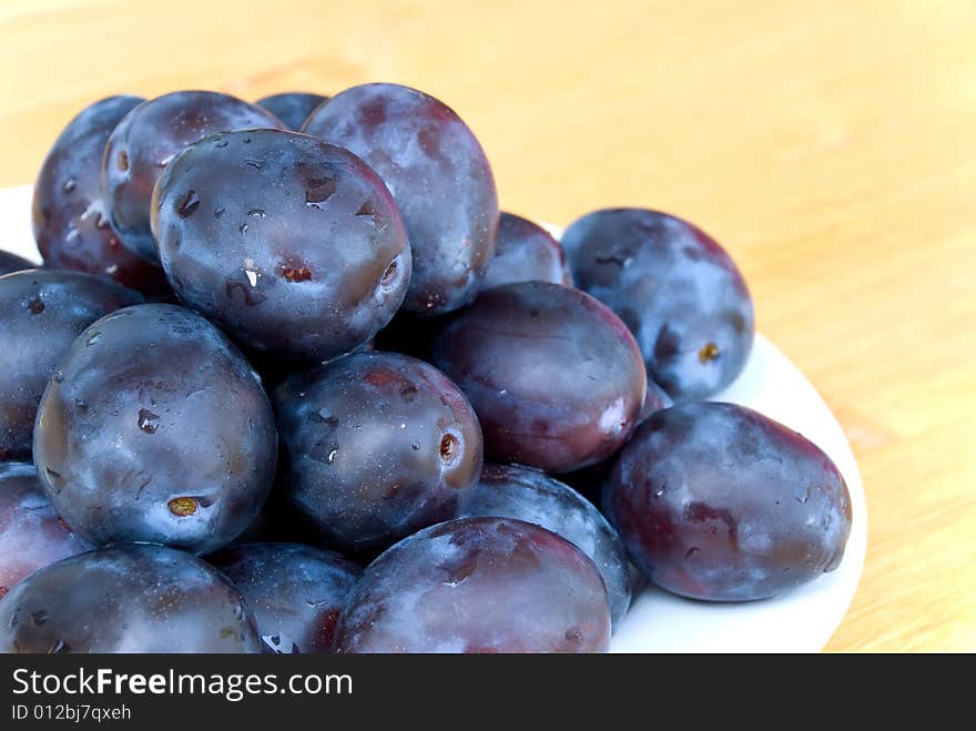 Stack of Plums on wooden background