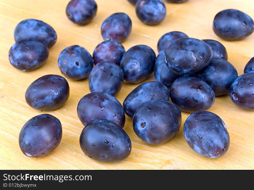 Stack of Plums on wooden background