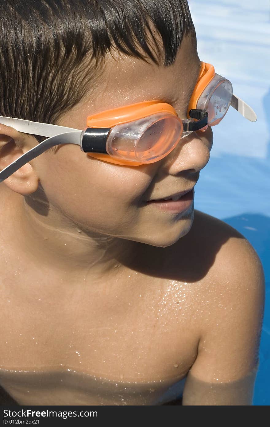 Young boy in pool with goggles on. Young boy in pool with goggles on