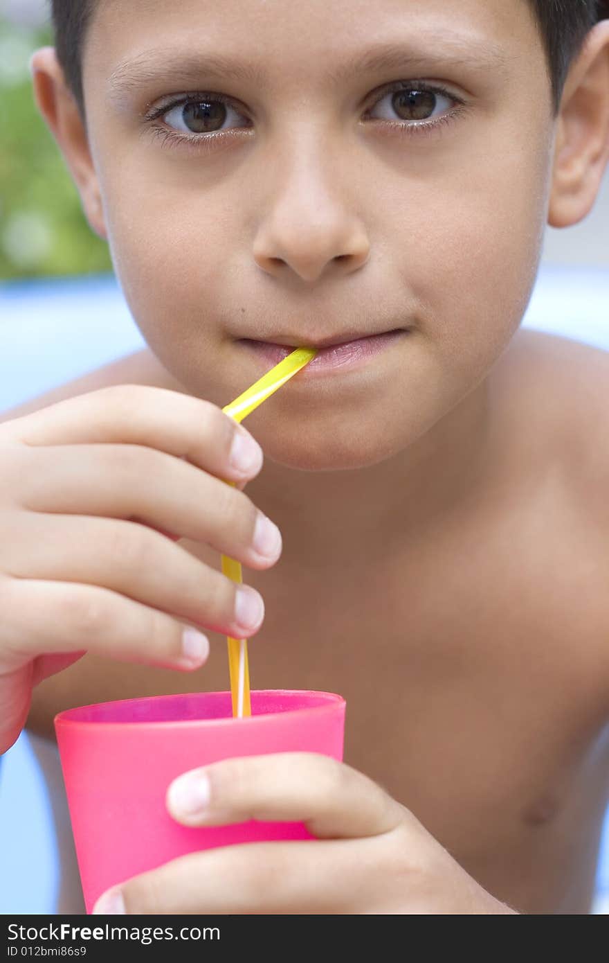 Cute young boy drink juice