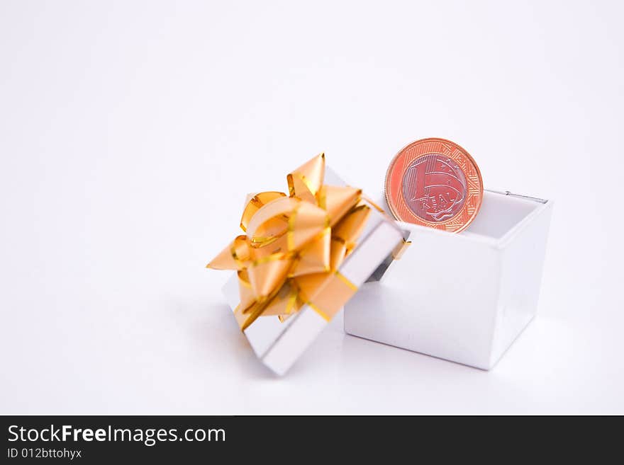 Box to gift and coin on the white background