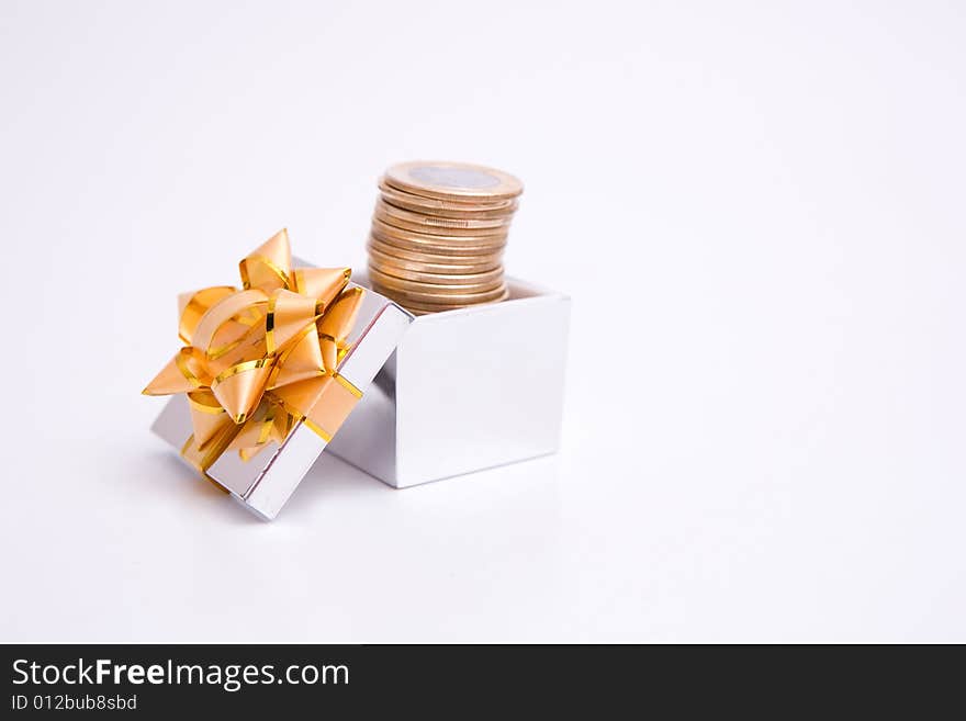 Box to gift and coin on the white background