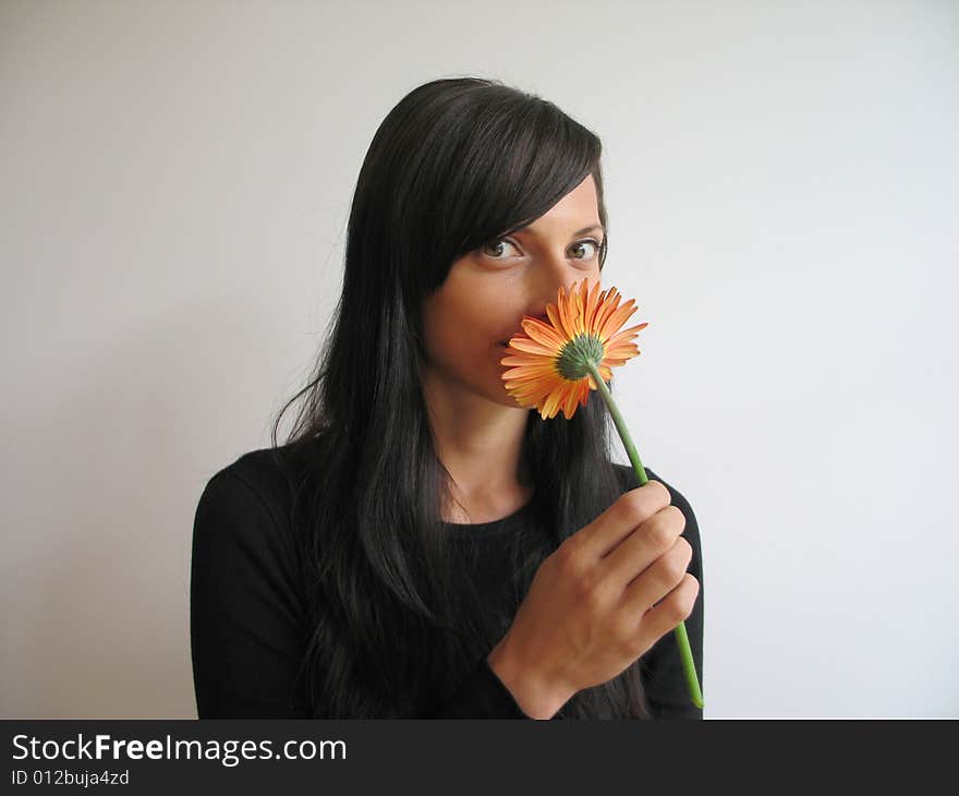 A pretty girl smelling a flower