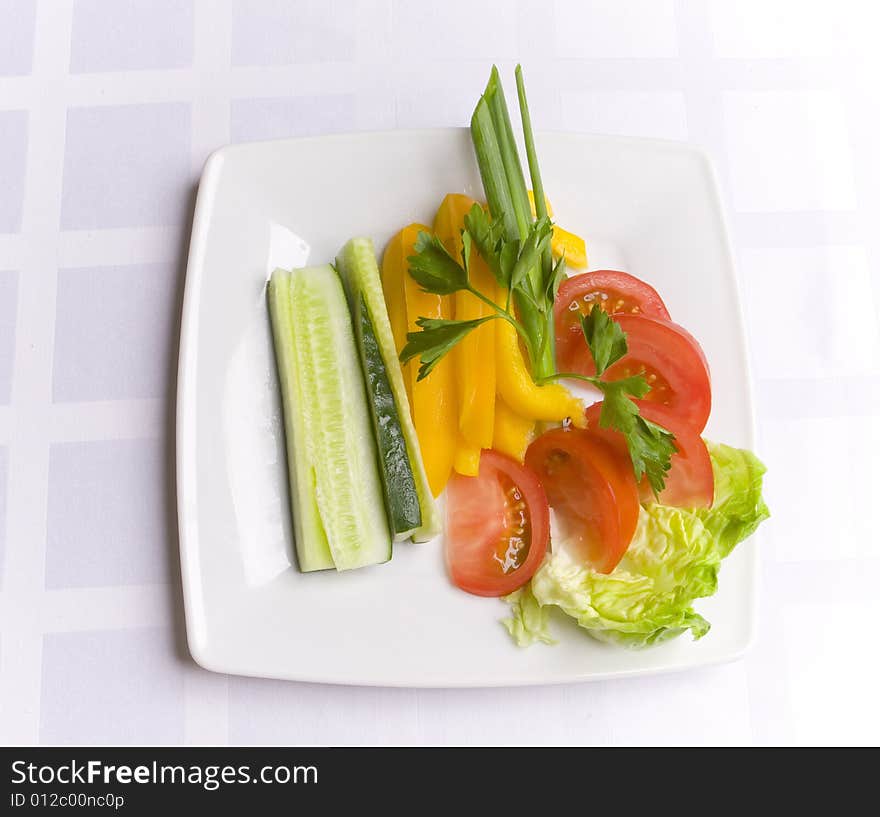 Vegetables with herbs on white plate