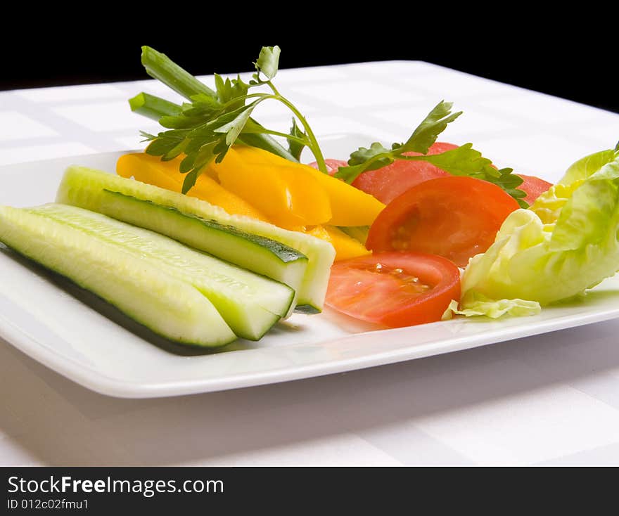 Vegetables with herbs on white plate