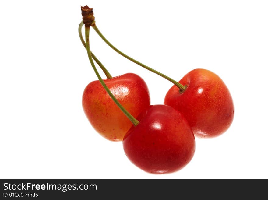 Three cherries isolated on white background